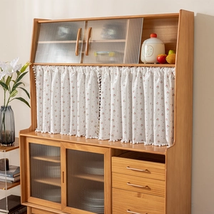 Japanese style wooden sideboard with fluted glass doors and floral print curtain