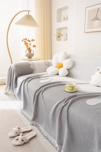 Detail of Nordic chenille sofa throw with wave patterns and decorative fringe edges