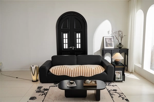 Detail of jacquard sofa cover showing thick wave texture on a black leather couch