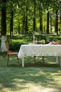 French cotton tablecloth with colorful geometric embroidery and elegant ruffled edges