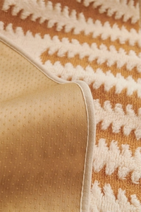 Close-up of jacquard sofa cushion showing textured plush surface and non-slip backing