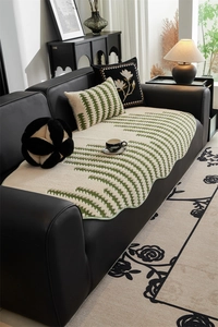 Close-up of cream jacquard sofa cushion with green wavy texture and premium plush fabric