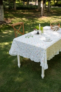 Close-up of French cotton tablecloth with colorful geometric patterns and ruffled edges