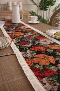 Macro detail of vintage floral jacquard table runner with decorative cream tassels