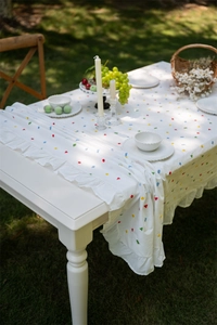 Detail of French cotton tablecloth showing geometric prints and ruffled edge trim