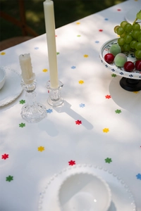 Detail of French cotton tablecloth showing colorful floral embroidery and textured weave