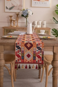 Detailed close-up of retro geometric jacquard table runner with colorful tassels