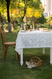 Close-up of French lace tablecloth with leaf embroidery and hollow edges in nature
