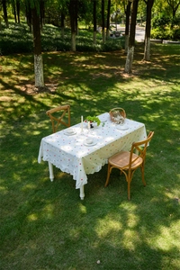 Detail of French cotton tablecloth featuring ruffle edges and colorful polka dot embroidery