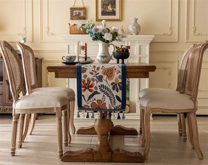Detailed view of vintage floral jacquard table runner with blue fringe tassels