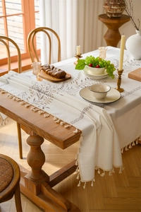 Detailed embroidery of coffee leaves and floral tassels on premium cotton linen tablecloth