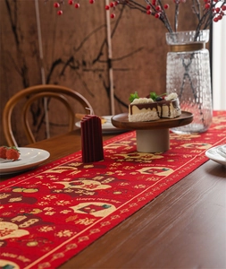 Detail of red New Year table runner with gold floral patterns and Happy New Year text