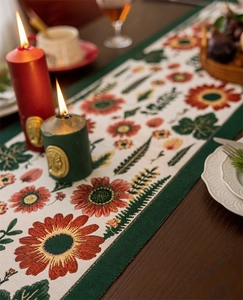 Detail of vintage floral jacquard table runner with sunflower and fern leaf patterns
