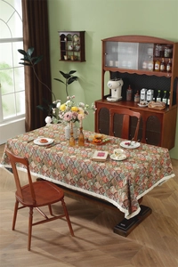 Detail of vintage Jacquard tablecloth with scalloped patterns and white tassel fringe