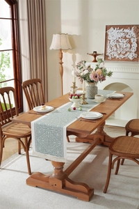 Detailed view of Morandi blue jacquard table runner with decorative white tassels