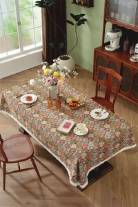 Detail of retro jacquard tablecloth with colorful scalloped patterns and white fringe
