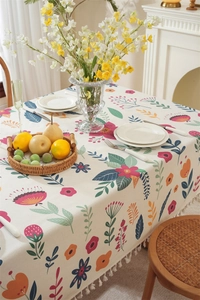Close-up of Easter floral tablecloth with elegant fringe tassels on cotton-linen fabric