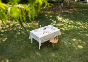 Detailed texture of white cotton tablecloth with colorful dots and pom-pom edge trim