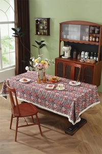 Detailed close-up of retro jacquard tablecloth with scalloped patterns and white tassels