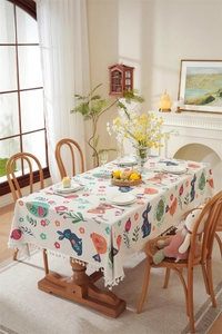 Detailed view of rectangle tablecloth with Easter rabbit patterns and tassel fringe edge