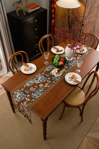 Vue de dessus du chemin de table jacquard marron avec motifs floraux et pompons