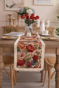 Macro detail of retro floral jacquard table runner with decorative tassel fringe edges