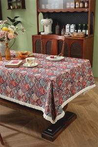 Detailed shot of retro jacquard tablecloth with scallop patterns and beige fringe edges