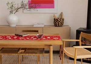 Detail of red Chinese festive table runner featuring golden lanterns and Fu character patterns