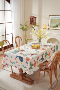 Detail of Easter rectangular tablecloth with bunny and floral print in cozy home setting
