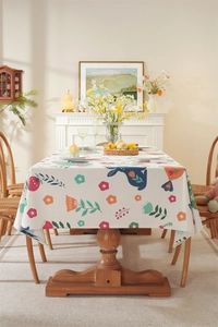 Detail of Easter tablecloth with floral and blue bunny patterns and elegant tassels