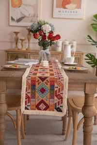 Macro detail of bohemian table runner showing jacquard weave and cream tassels