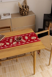 Close-up of festive red Chinese table runner with gold Fu characters and tassel fringe