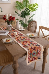 Detailed view of bohemian geometric jacquard table runner with decorative cream tassels