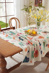 Detail view of Easter rectangle tablecloth with colorful bunny floral print and tassel edges