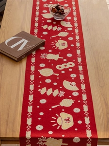Close-up of red festive table runner with gold fans, lanterns and Fu character patterns