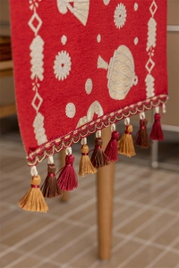 Macro detail of Chinese red table runner with jacquard patterns and tricolor tassels