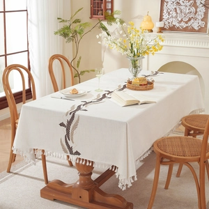 Elegant rectangular white tablecloth with leaf embroidery and decorative tassels