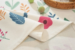 Close-up of Easter floral print linen tablecloth featuring fringe edges and fine stitching