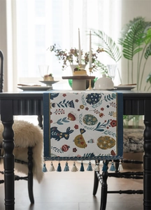 Detail of Easter table runner with blue rabbit and egg patterns plus elegant tassels