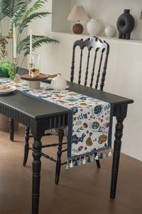 Detail of Easter table runner featuring blue rabbit patterns and hanging tassels