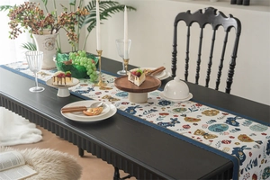 Detailed woven Easter table runner featuring blue rabbits and spring floral patterns