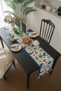 Detail of Easter table runner with blue rabbit, eggs pattern and colorful tassels