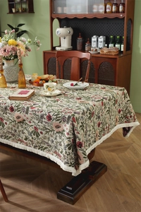 Detailed macro view of retro floral jacquard tablecloth with beige fringe edges
