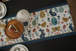 Detail of Easter table runner with blue rabbit and floral motifs on woven fabric