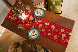 Detail of red festive table runner with golden koi fish, lanterns, and cloud patterns