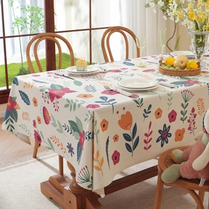 Easter floral rectangular tablecloth with tassels and colorful botanical print on wooden table