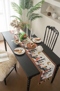 Detailed view of Middle Eastern style table runner with moon pattern and colorful tassels