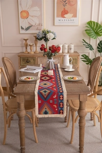Close-up of ethnic geometric woven table runner with intricate tassels and rich blue textures