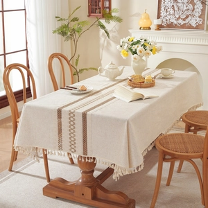 Minimalist rectangular beige linen table runner with brown geometric patterns and tassels