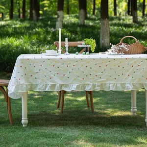 French cotton rectangular tablecloth with colorful geometric floral embroidery and ruffled edges